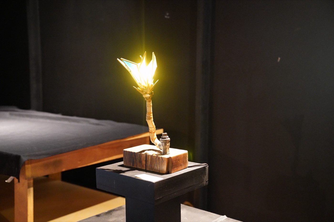 Illuminated sculpture on pedestal