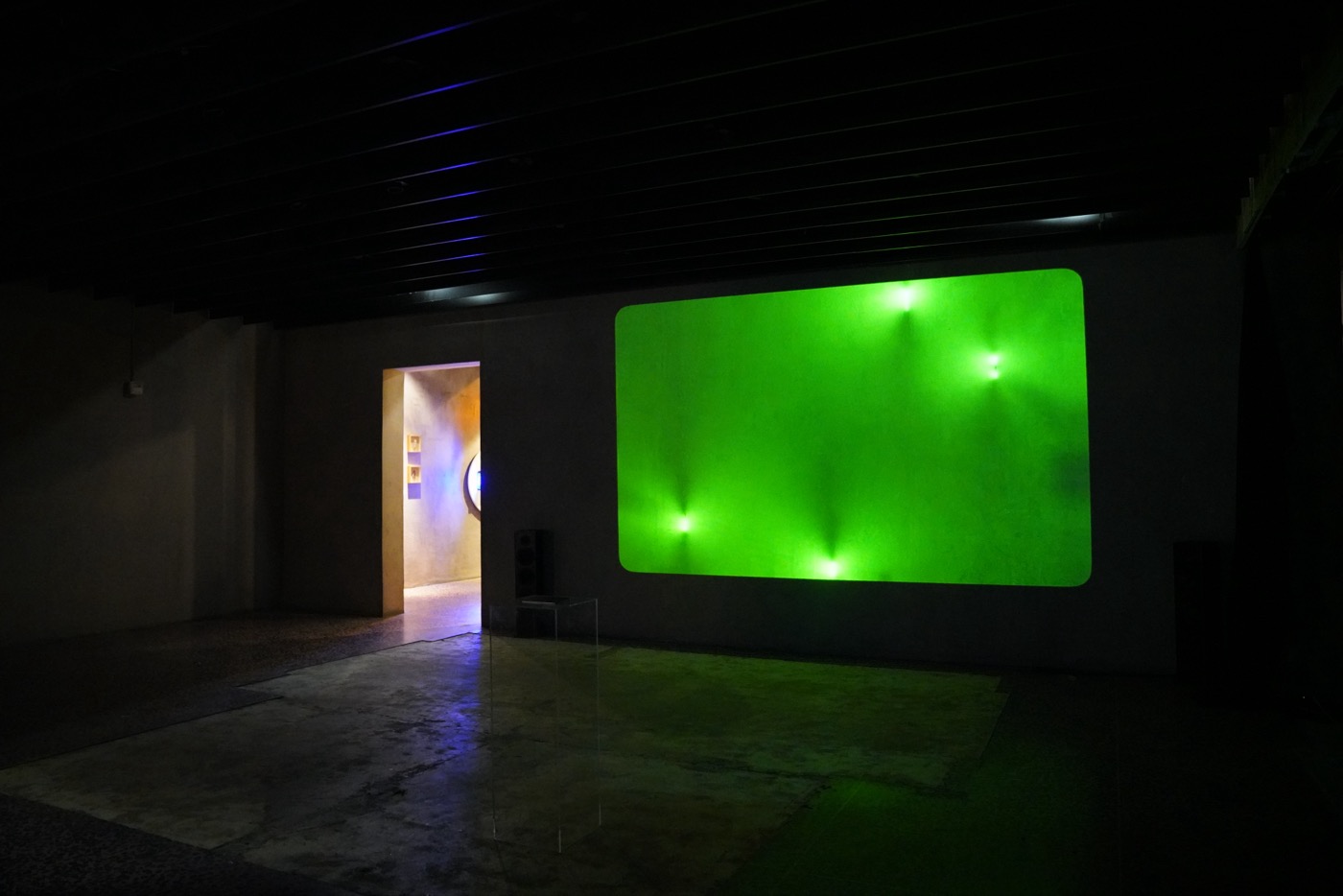 Green light projection in gallery room