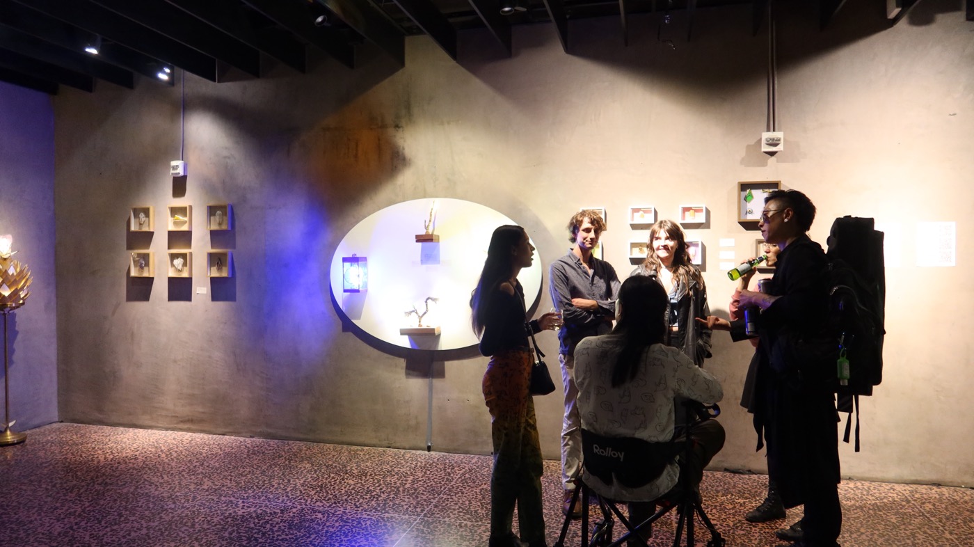 Visitors chatting near mirror installation